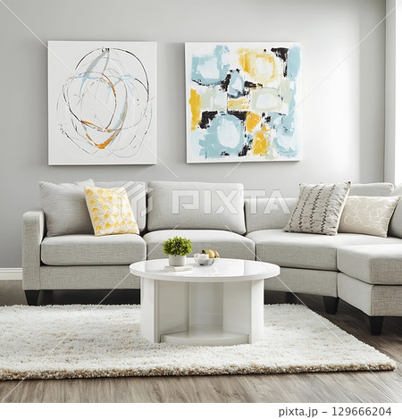 A white couch is in the middle of a living room with a white coffee table 129666204