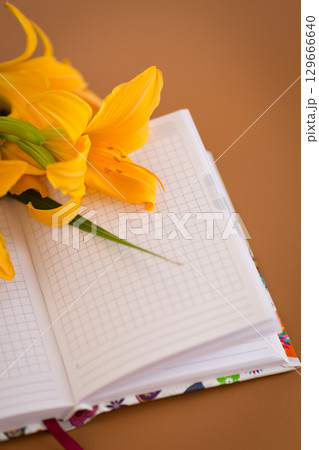 Floral notebook background in Pantone Mocha Mousse tone 129666640