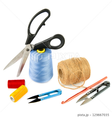 Ball of hemp rope, crochet hook and scissors isolated on white background. 129667035