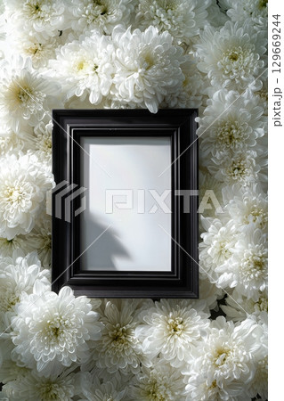 Black funeral frame with white chrysanthemums in a solemn hyper-real tribute scene 129669244