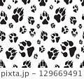 Black silhouettes of prints of dog paws, Seamless pattern 129669491