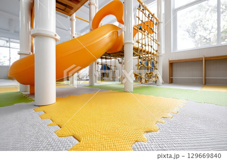 Colorful rubber flooring in a children's play area with slides and climbing structures 129669840