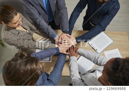 Business people group putting their hands on top of each other 129669988