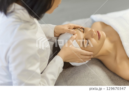 Facial massage face skin treatment, therapist or esthetician, beautician doctor, dermatologist 129670347