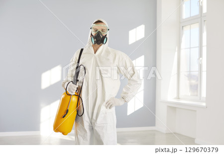 Pest exterminator, professional disinfection service worker standing posing, pest control  Pest exterminator, professional disinfection service worker standing posing, pest control  129670379