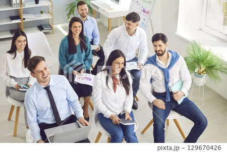 Business people sitting on a meeting in office listening to colleague during a conference. 129670426