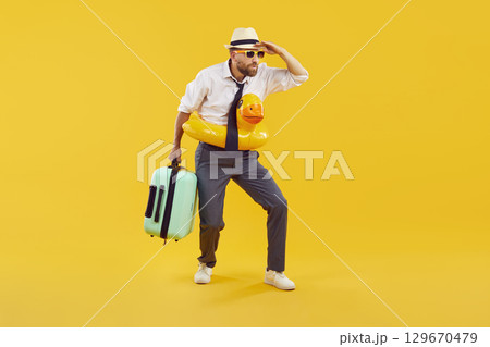 Funny business man traveling on holiday, holding hand on forehead and looking in distance Funny business man traveling on holiday, holding hand on forehead and looking in distance 129670479