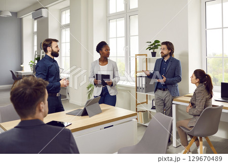 Team of multiracial business people talking during a group work meeting in the office Team of multiracial business people talking during a group work meeting in the office 129670489
