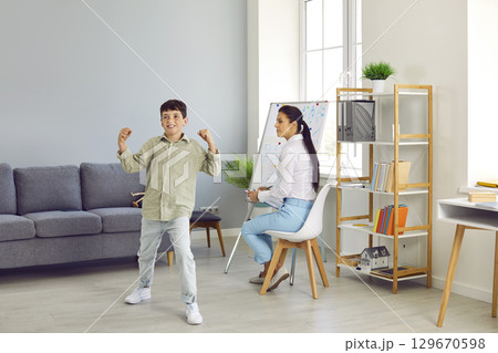 Hyperactive ADHD child or bully boy at therapist's or school psychologist's office Hyperactive ADHD child or bully boy at therapist's or school psychologist's office 129670598