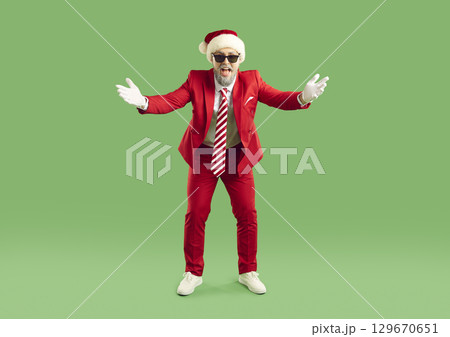 Happy man wearing christmas hat doing welcome gesture Happy man wearing christmas hat doing welcome gesture 129670651