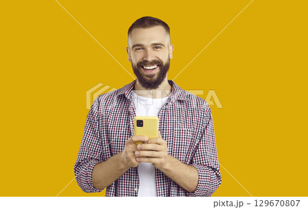 Man uses mobile phone to communicate in social networks, order services online and use mobile apps. Man uses mobile phone to communicate in social networks, order services online and use mobile apps. 129670807