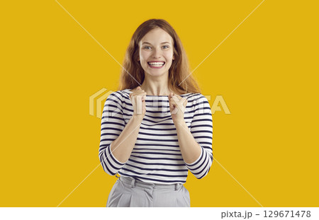 Excited woman clenching fists impatiently waiting for results anticipating her success and victory. Excited woman clenching fists impatiently waiting for results anticipating her success and victory. 129671478