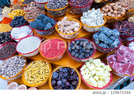 Traditional spices market. Pots and wooden tubs stand in row with colorful tea, spices, fruits, roots, flowers. Street bazaar. Dubai, UAE. Traditional spices market. Pots and wooden tubs stand in row with colorful tea, spices, fruits, roots, flowers. Street bazaar. Dubai, UAE. 129671568