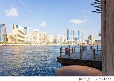 Old town in Al Seef Cultural Historical District. Beautiful view of water, old houses and new ones of Dubai Creek, Dubai, UAE. Taken off hand. High quality photo Old town in Al Seef Cultural Historical District. Beautiful view of water, old houses and new ones of Dubai Creek, Dubai, UAE. Taken off hand. High quality photo 129671572