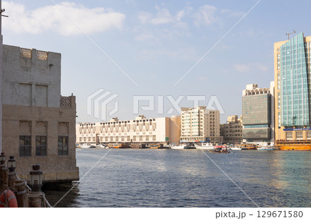 Old town in Al Seef Cultural Historical District. Beautiful view of water, old houses and new ones of Dubai Creek, Dubai, UAE. Taken off hand. High quality photo Old town in Al Seef Cultural Historical District. Beautiful view of water, old houses and new ones of Dubai Creek, Dubai, UAE. Taken off hand. High quality photo 129671580