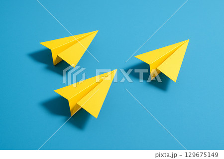A yellow airplane breaking through group formation flying ahead as trailblazing leadership 129675149