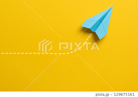 A yellow airplane moving ahead with dotted path symbolizing leadership initiative A yellow airplane moving ahead with dotted path symbolizing leadership initiative 129675161