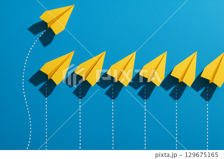 Four yellow airplanes in front leading blue airplanes in a square arrangement representing structured leadership 129675165
