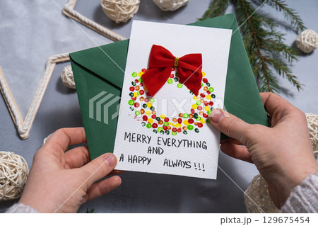 Christmas wreath Gift Christmas idea. Do it yourself instruction postcard eco-friendly decoration. Making handmade presents children's diy projects. Holiday family time 129675454