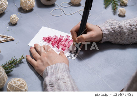 Christmas tree ribbon Storytelling of creating craft Christmas greeting card holiday present. Tactile hand-on activity. Master class progress of creative me-made gifts. Seasonal domestic life micro 129675455