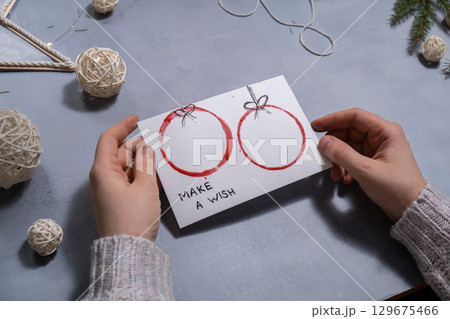 Christmas balls Storytelling of creating craft Christmas greeting card holiday present. Tactile hand-on activity. Master class progress of creative me-made gifts. Seasonal domestic life micro moment 129675466