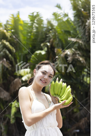 バナナを持つかわいい女性 129675565