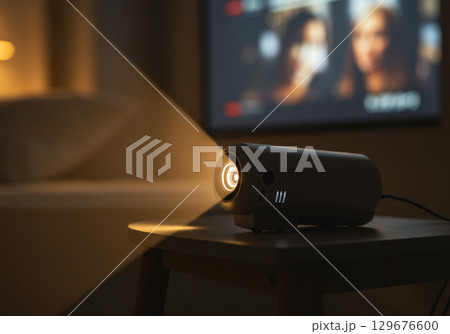 Mini Projector Streaming on Small Table at Night 129676600