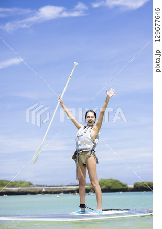 SUPを楽しむかわいい女性 129677646