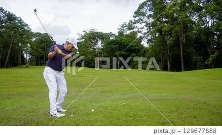 Golfers are playing golf in the evening golf course golf backglound. 129677888