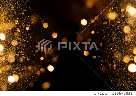 Golden sparkle illuminating an elegant dark space background. 129679832