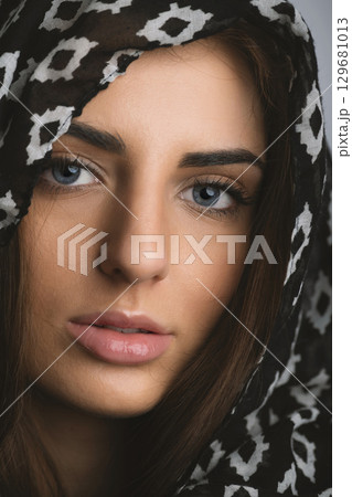 Close-up beautiful woman portrait with scarf on her head Close-up beautiful woman portrait with scarf on her head 129681013