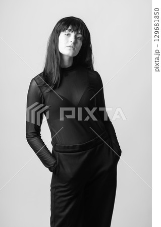 Woman portrait with dark hairs and outfit Woman portrait with dark hairs and outfit 129681850