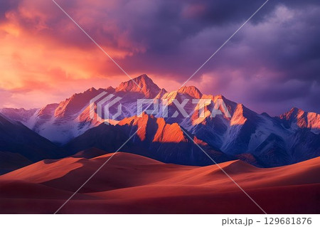 Dramatic Sunset Over Snow-Capped Peaks and Red Sand Dunes Landsc 129681876