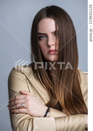 Beautiful woman with long dark hair studio portrait 129682226