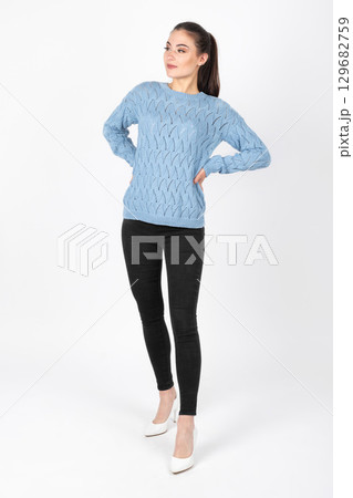 Beautiful woman portrait with blue sweater and black jeans 129682759