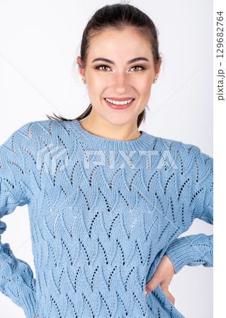 Beautiful woman studio portrait wearing blue sweater 129682764