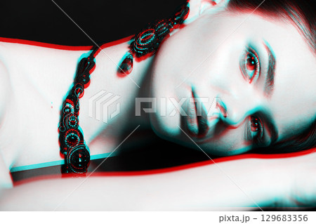 Beautiful woman with fancy necklace and earrings studio portrait in RGB color split effect Beautiful woman with fancy necklace and earrings studio portrait in RGB color split effect 129683356
