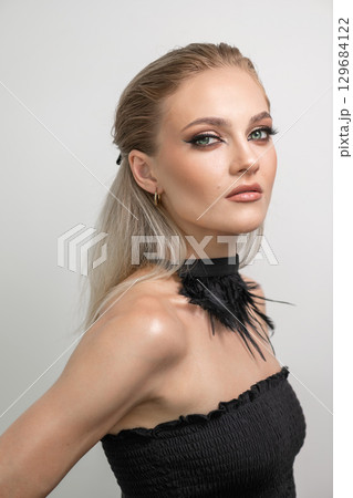 Beautiful woman with smokey makeup close up studio portrait 129684122