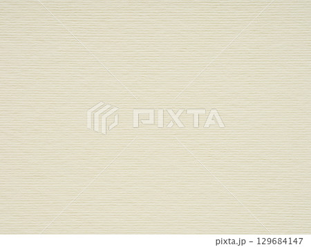 A detailed examination reveals the subtle nuances of a beige paper's surface, hinting at its tactile story 129684147