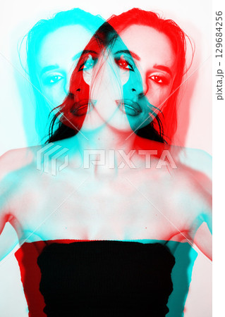 Beautiful woman with smokey make-up close-up studio portrait in RGB color split effect Beautiful woman with smokey make-up close-up studio portrait in RGB color split effect 129684256
