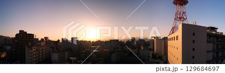 Sunrise over the city in spring 春の街を照らす御来光・日の出(4月) 129684697