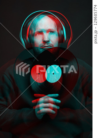 Man with sweatshirt headphones and LP vinyl studio portrait in glitch and RGB color split effect style 129685774