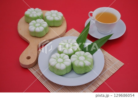 Traditional Indonesian Pandan Cake with Cup of Tea Traditional Indonesian Pandan Cake with Cup of Tea 129686054