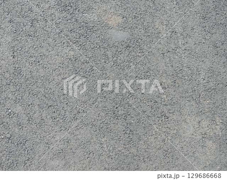 gray asphalt background full frame with ribbed dotted surface in rough texture, concrete or cement floor or wall covering as textured plain backdrop gray asphalt background full frame with ribbed dotted surface in rough texture, concrete or cement floor or wall covering as textured plain backdrop 129686668