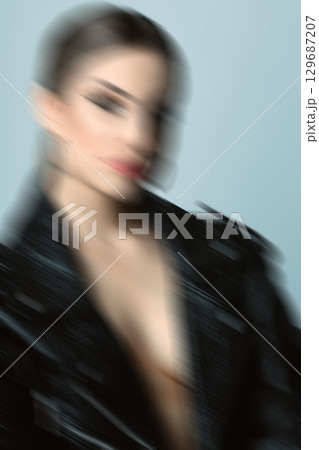 Woman studio portrait with black punk leather jacket and without bra in motion blur style Woman studio portrait with black punk leather jacket and without bra in motion blur style 129687207