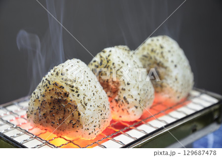煙りの立ち昇る七輪でお握りを焼く 煙りの立ち昇る七輪でお握りを焼く 129687478
