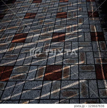 赤と白のタイルに差し込む斜めの影 129687636