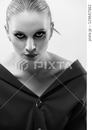 Beautiful and seductive looking woman close-up studio black and white portrait 129687862