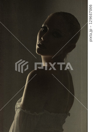 Beautiful woman dark silhouette studio retro vintage portrait Beautiful woman dark silhouette studio retro vintage portrait 129687866