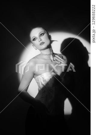 Beautiful woman black and white portrait illuminated with bright round studio light 129688222